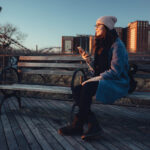Young,Attractive,Girl,In,Warm,Clothes,Holding,Mobile,Phone,While